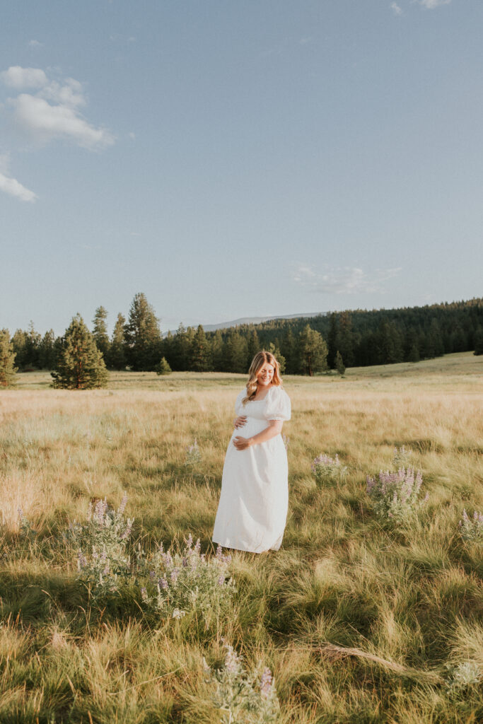 Maternity photo of pregnant lady in field of wild flowers