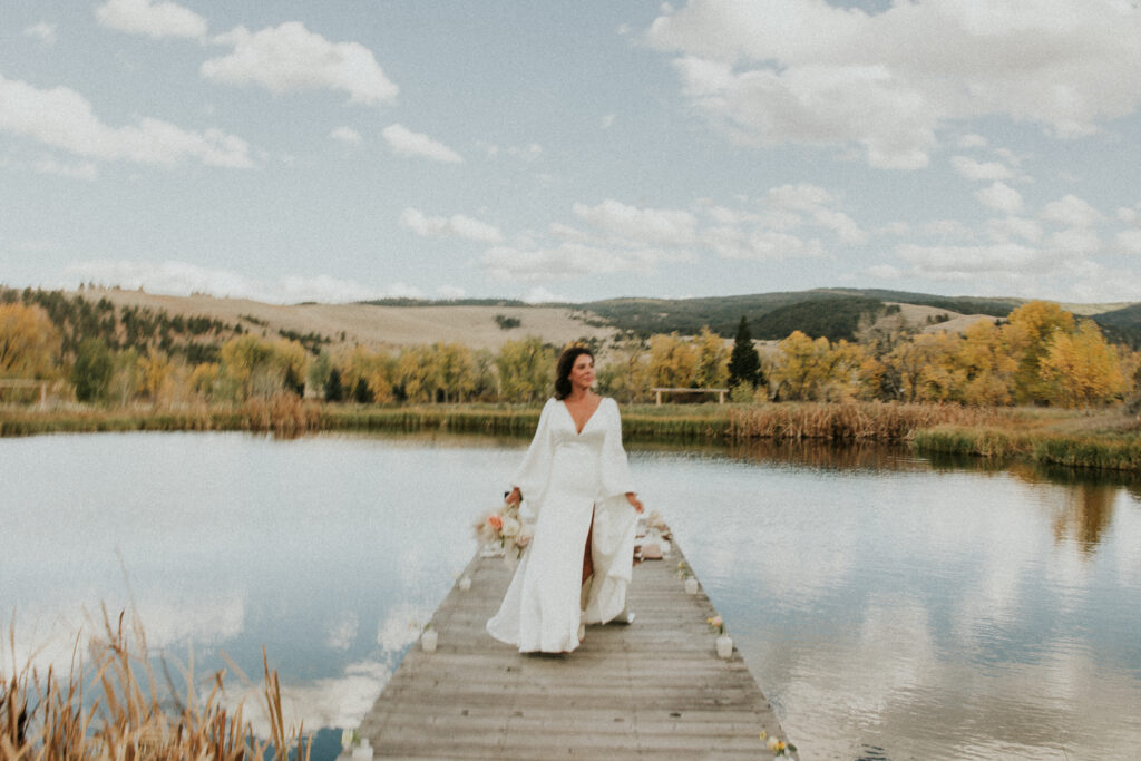 Bride walking at pond during elopement